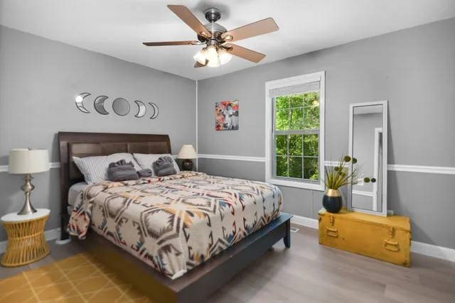 a bedroom with a bed couch and window