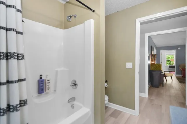 a bathroom with a tub a sink and a mirror