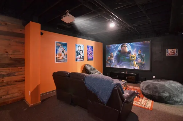 a projector room with furniture and screen