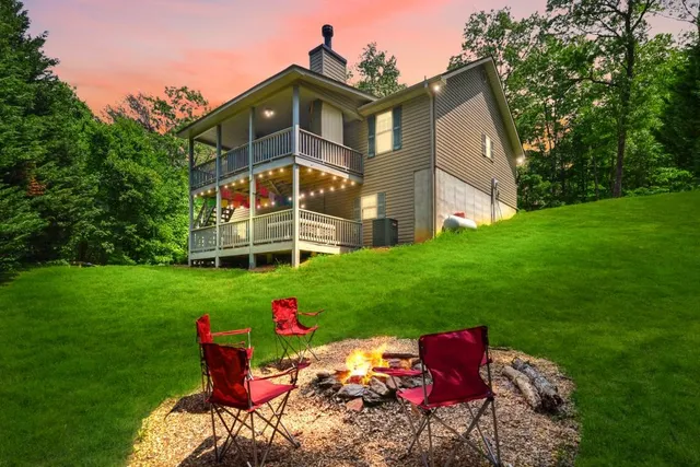 a front view of a house with a yard and garden