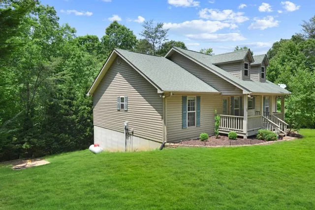 a front view of a house with a garden and yard