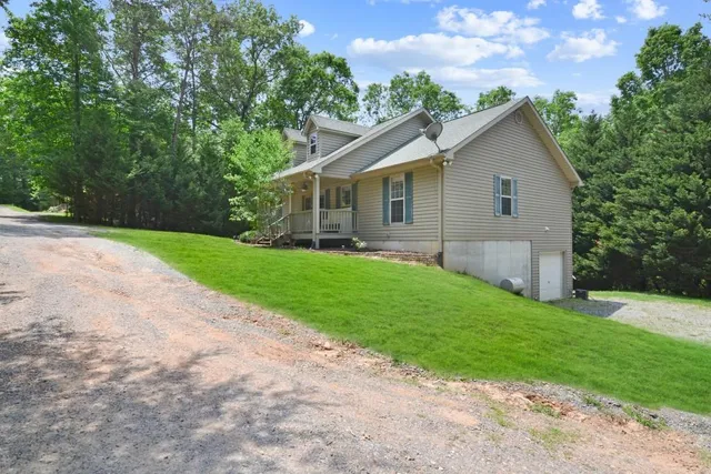 a view of a house with a yard and pathway