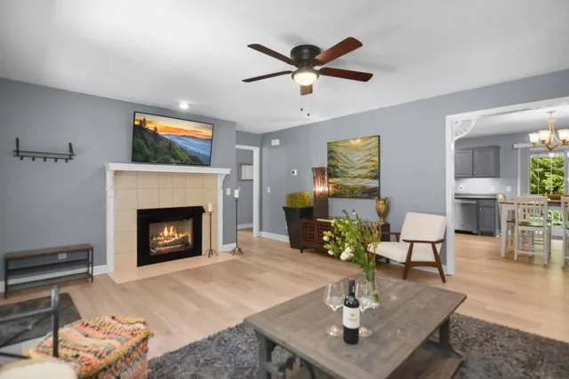a living room with furniture a fireplace and a table
