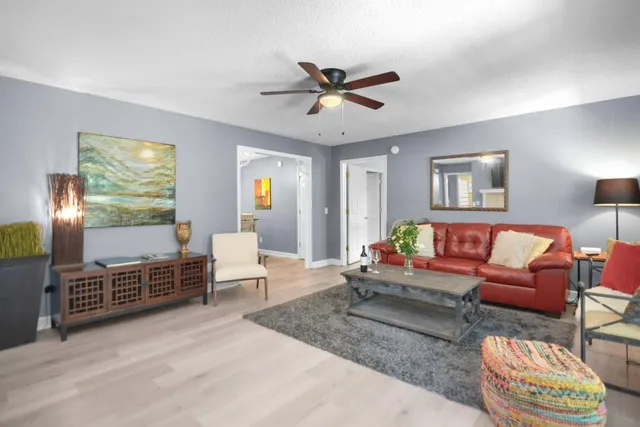 a living room with furniture a window and a chandelier