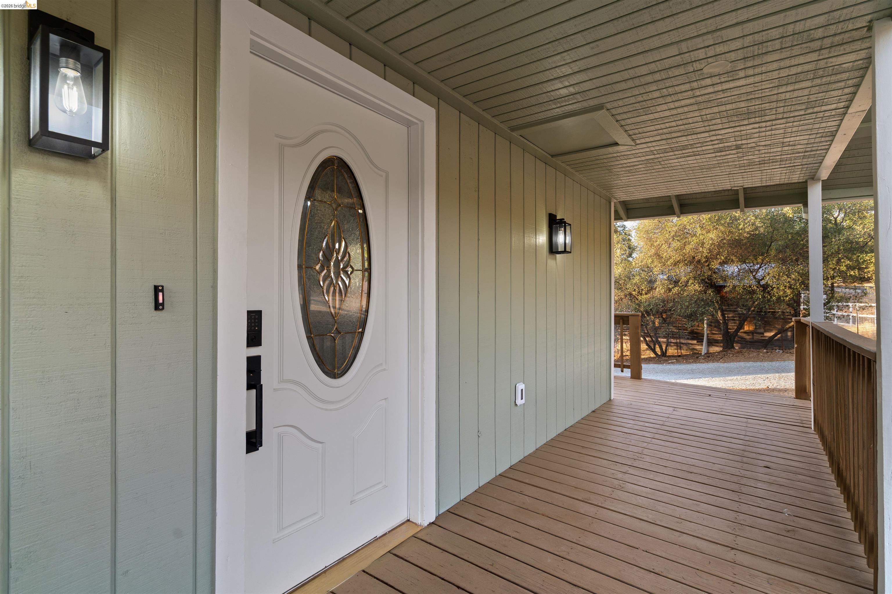 19676 Rawhide Road Sonora, CA 95370 - Photo 45 of 67 Covered front porch with wood-finish decking and vertical panel siding