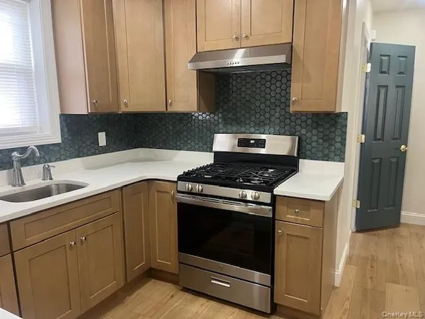a kitchen with a stove and a sink
