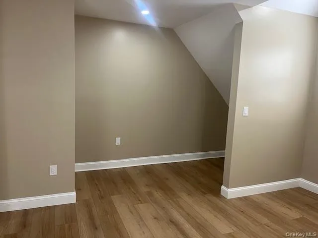 an empty room with wooden floor