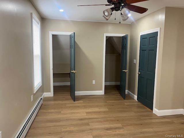 85-40 111th Street, Unit 2 Queens, NY 11418 - Photo 17 of 21 an empty room with wooden floor cabinet and a ceiling fan