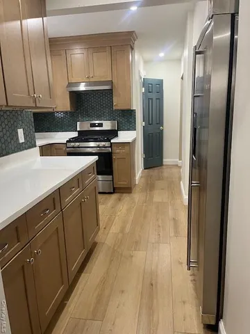 a kitchen with stainless steel appliances a refrigerator sink and microwave