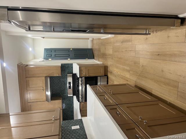 85-40 111th Street, Unit 2 Queens, NY 11418 - Photo 18 of 21 a kitchen with stainless steel appliances a refrigerator sink and microwave