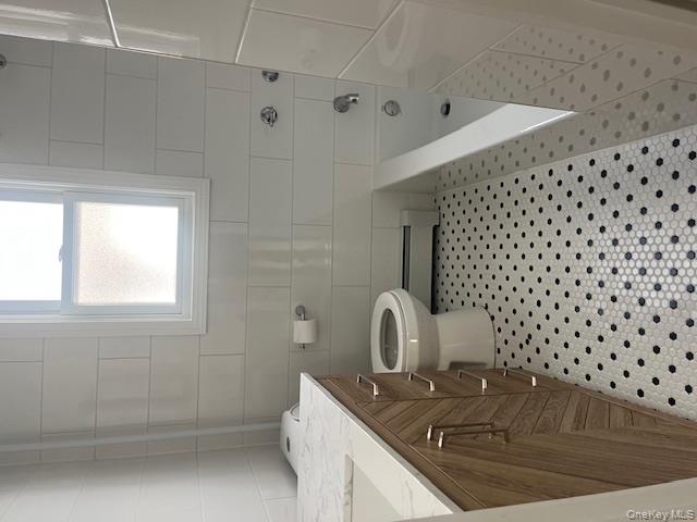 85-40 111th Street, Unit 2 Queens, NY 11418 - Photo 8 of 21 a bathroom with a sink a toilet a window and a shower