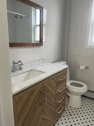 a bathroom with a sink toilet and mirror