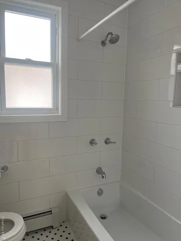 a bathroom with a bathtub and window