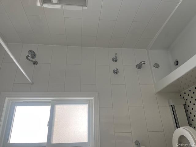 85-40 111th Street, Unit 2 Queens, NY 11418 - Photo 10 of 21 a bathroom with a bathtub and window