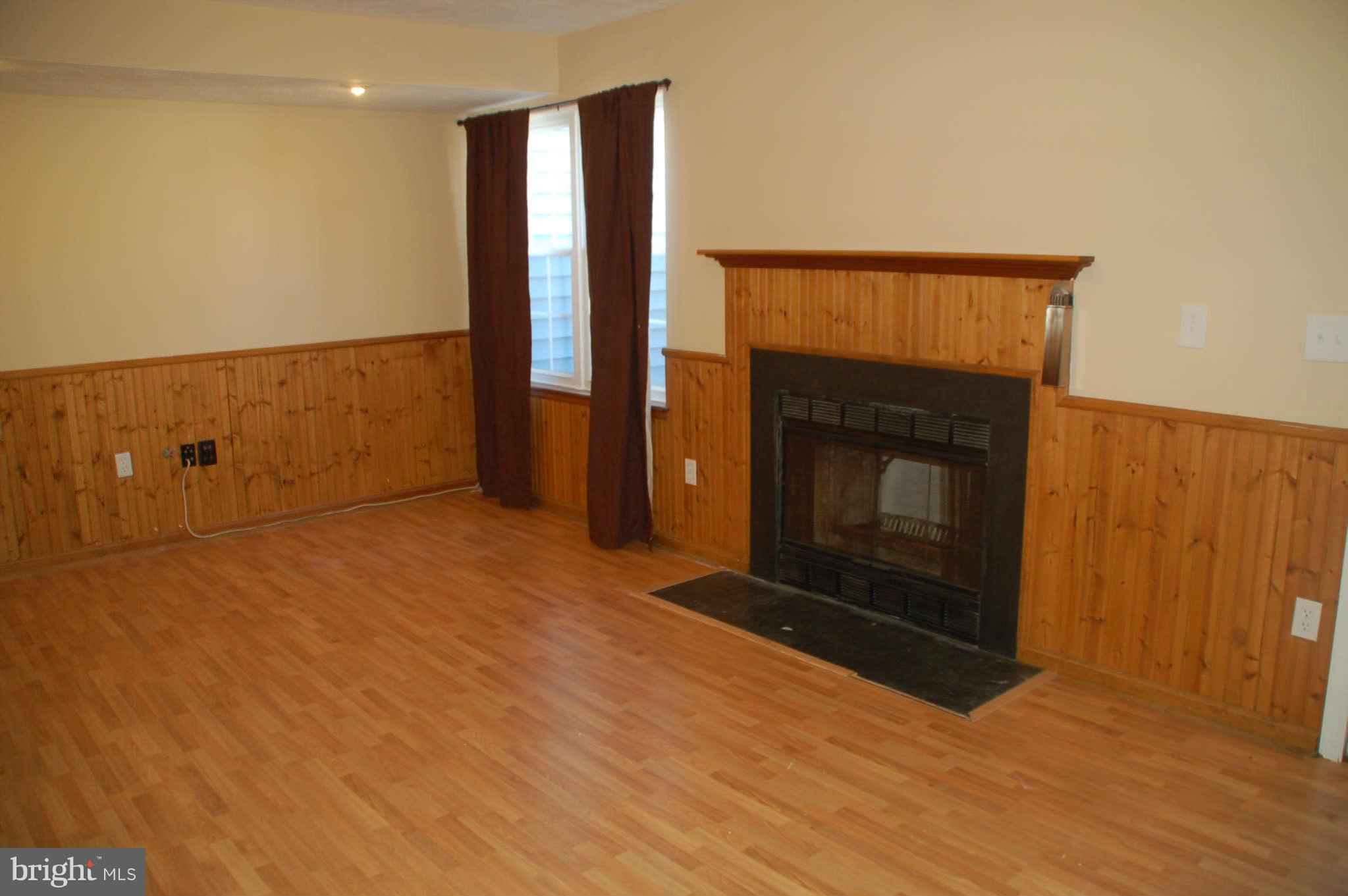 13982 New Braddock Road Centreville, VA 20121 - Photo 13 of 16 a view of empty room with wooden floor and fireplace
