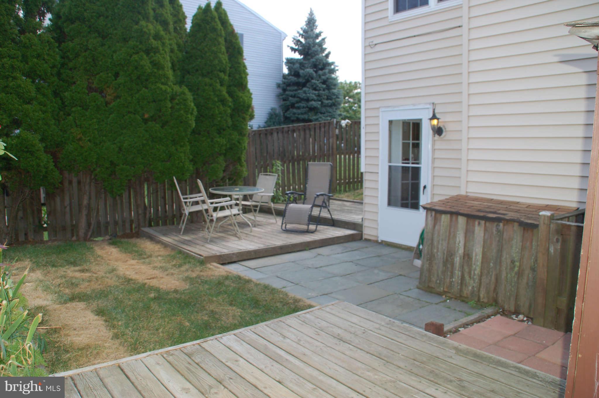 13982 New Braddock Road Centreville, VA 20121 - Photo 15 of 16 a view of a chair and table in backyard of the house