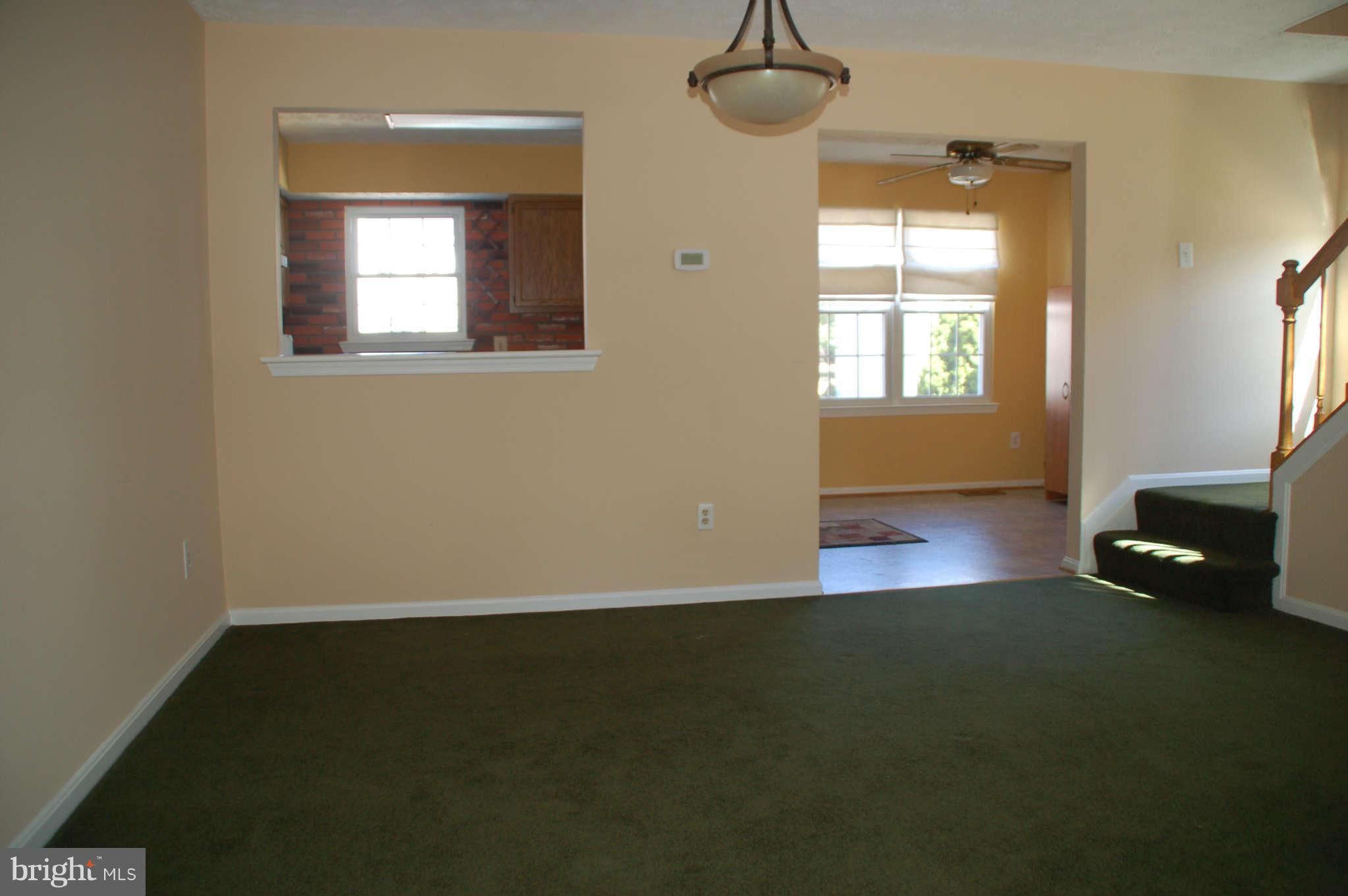 13982 New Braddock Road Centreville, VA 20121 - Photo 3 of 16 a view of an empty room with a window and wooden floor