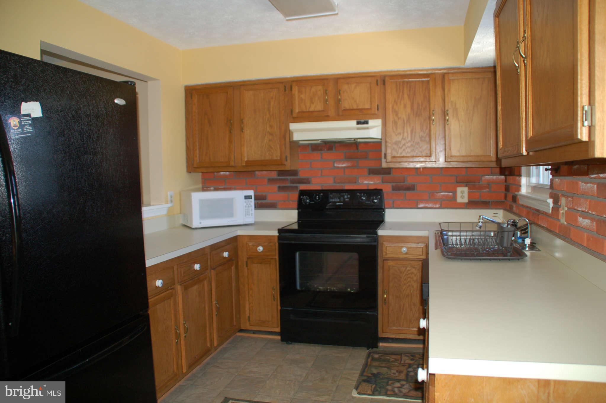 13982 New Braddock Road Centreville, VA 20121 - Photo 6 of 16 a kitchen with a sink appliances and cabinets