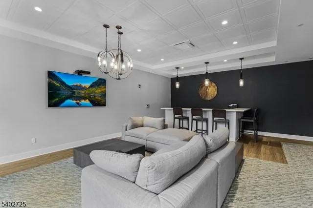 a living room with furniture and a chandelier