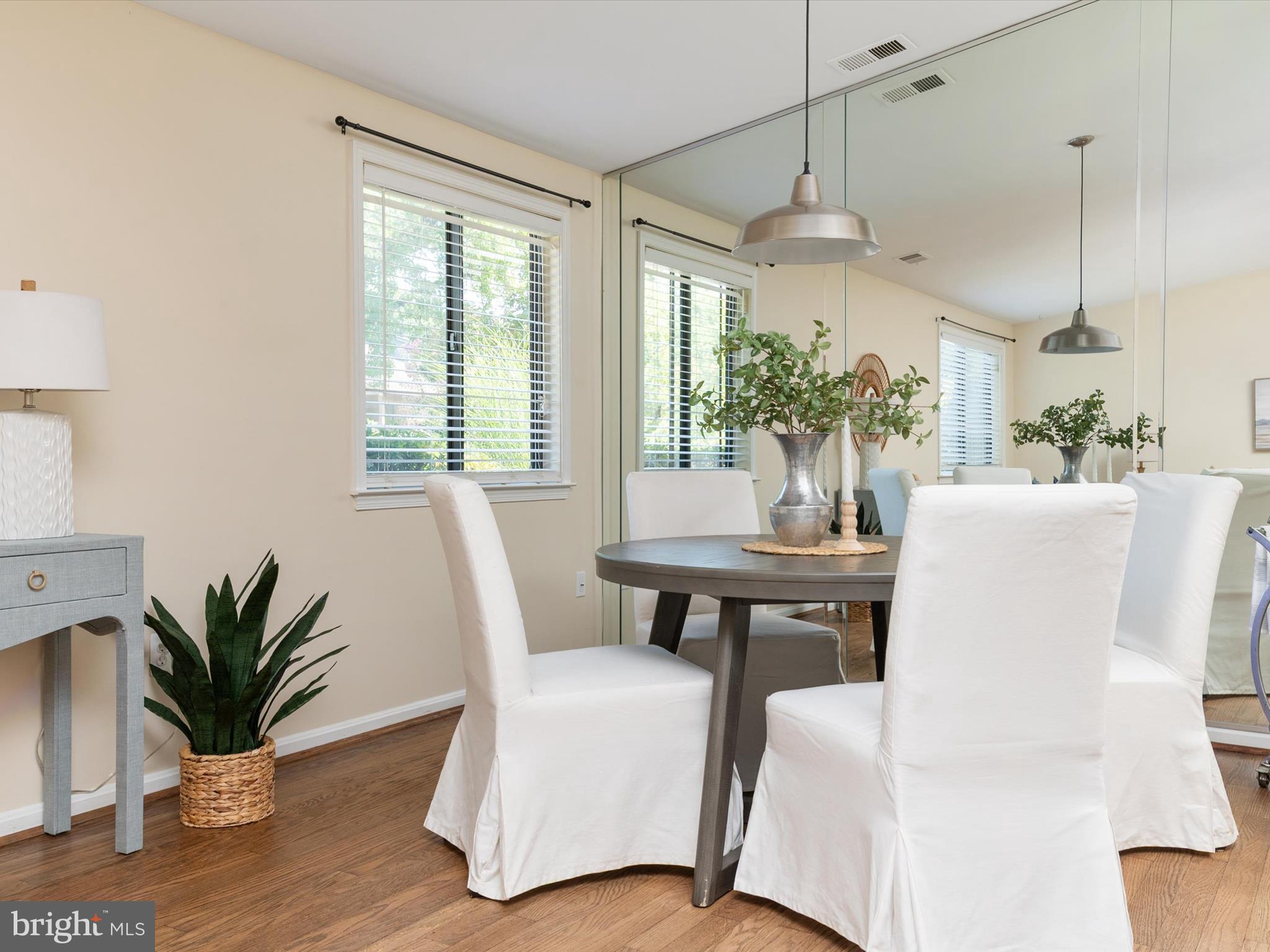 1411 Stonecreek Road Annapolis, MD 21403 - Photo 12 of 38 a dining room with furniture potted plants and wooden floor