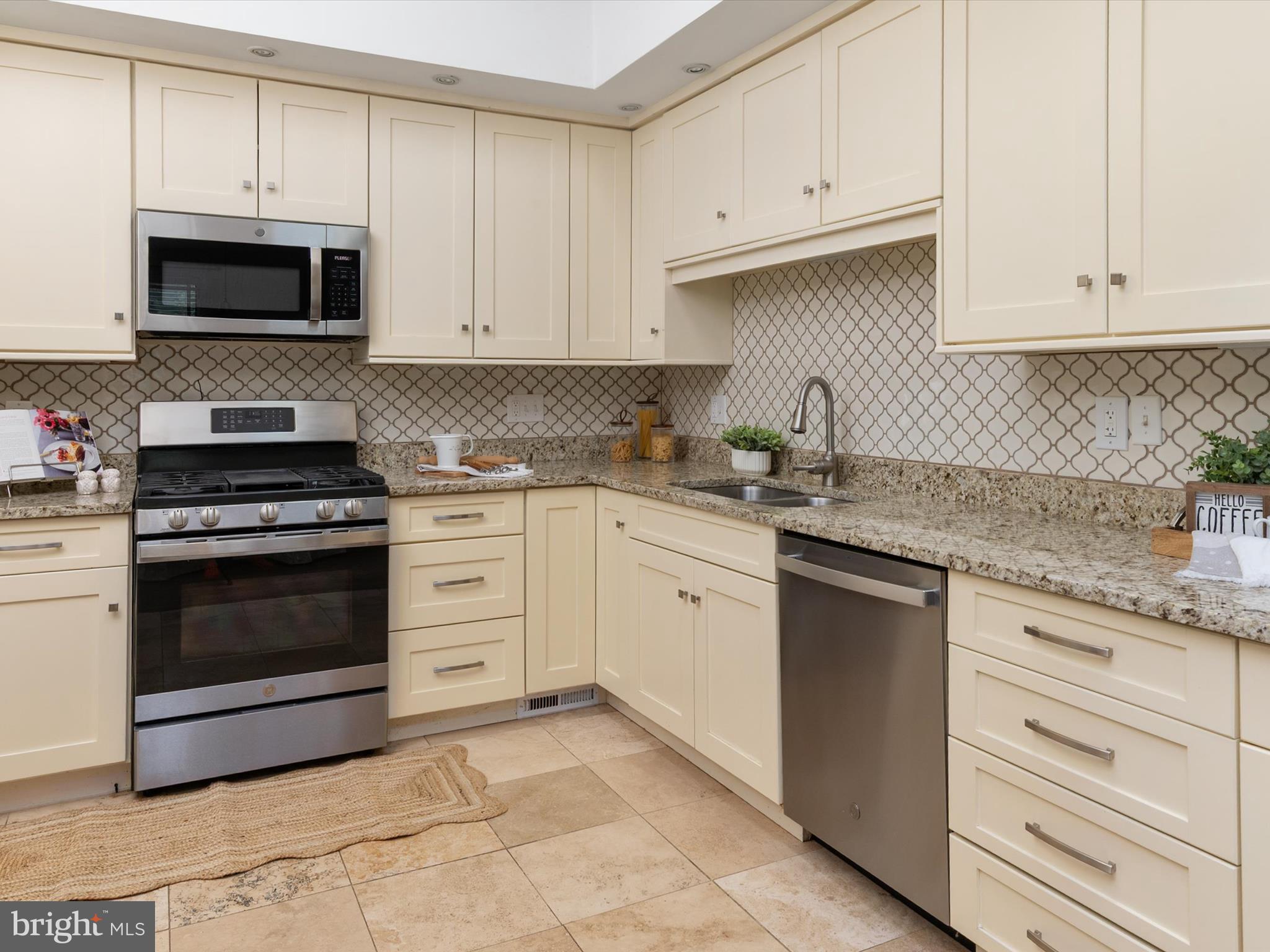 1411 Stonecreek Road Annapolis, MD 21403 - Photo 15 of 38 a kitchen with white cabinets and appliances