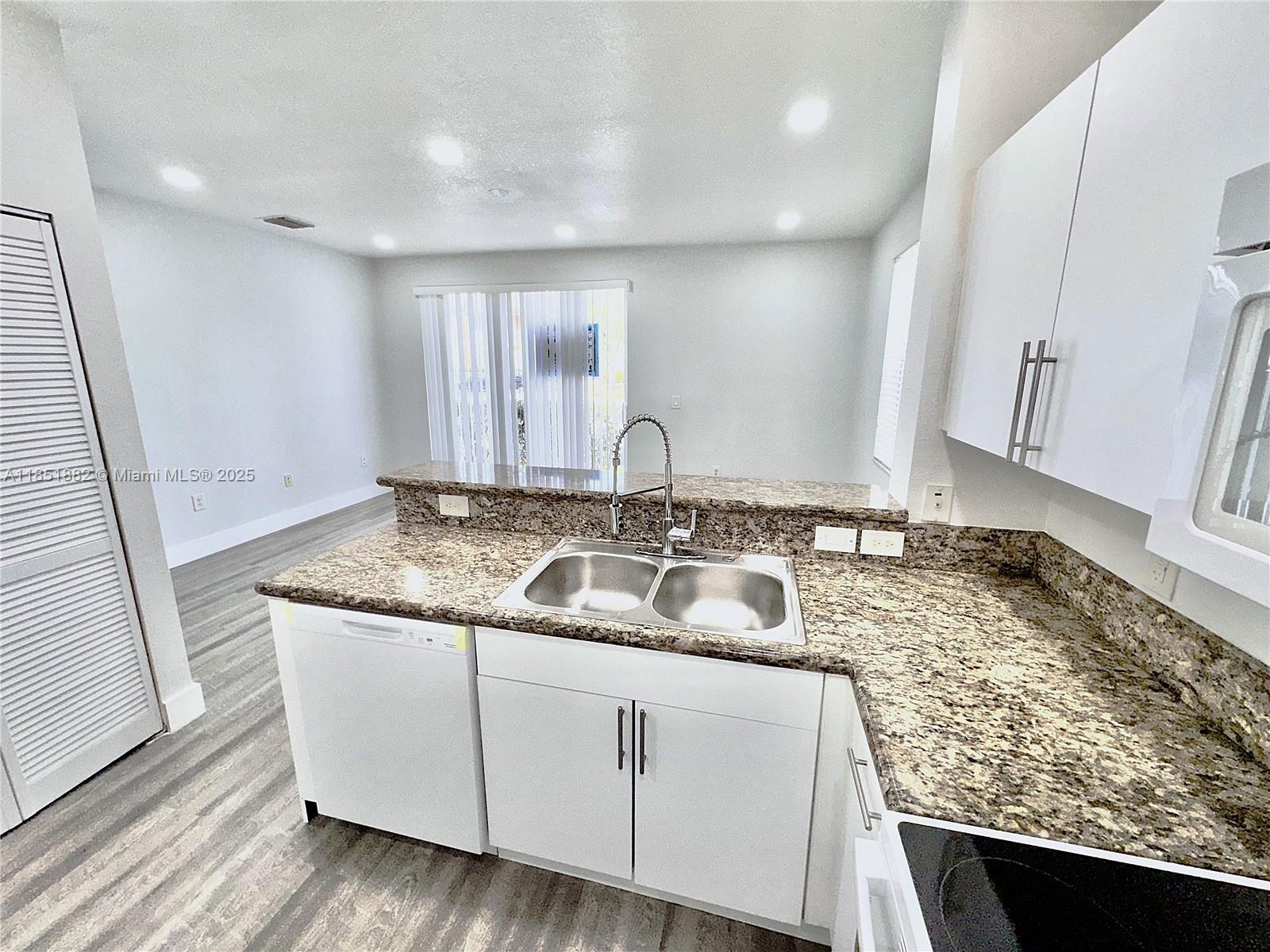 2933 Southeast 2nd Drive, Unit 2 Homestead, FL 33033 - Photo 15 of 38 a kitchen with sink and mirror