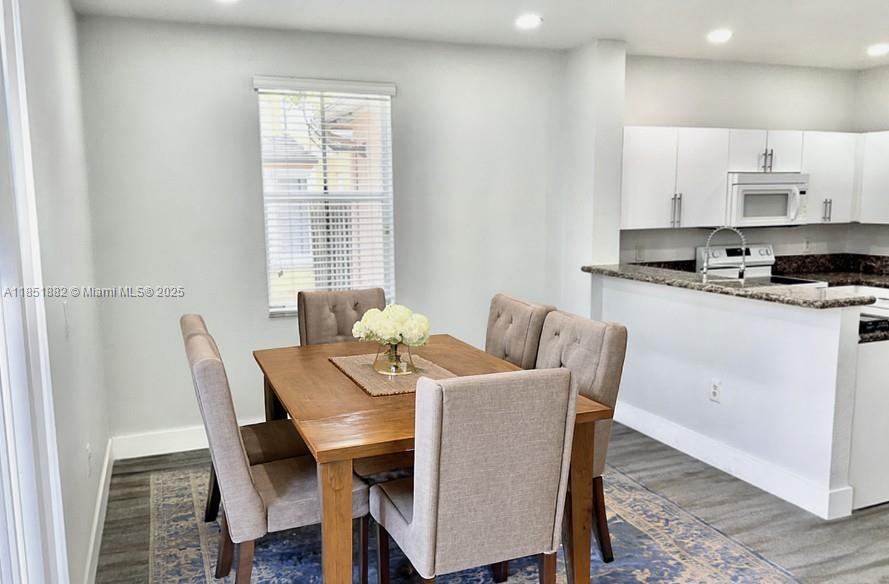 2933 Southeast 2nd Drive, Unit 2 Homestead, FL 33033 - Photo 18 of 38 a view of a dining room with furniture and wooden floor