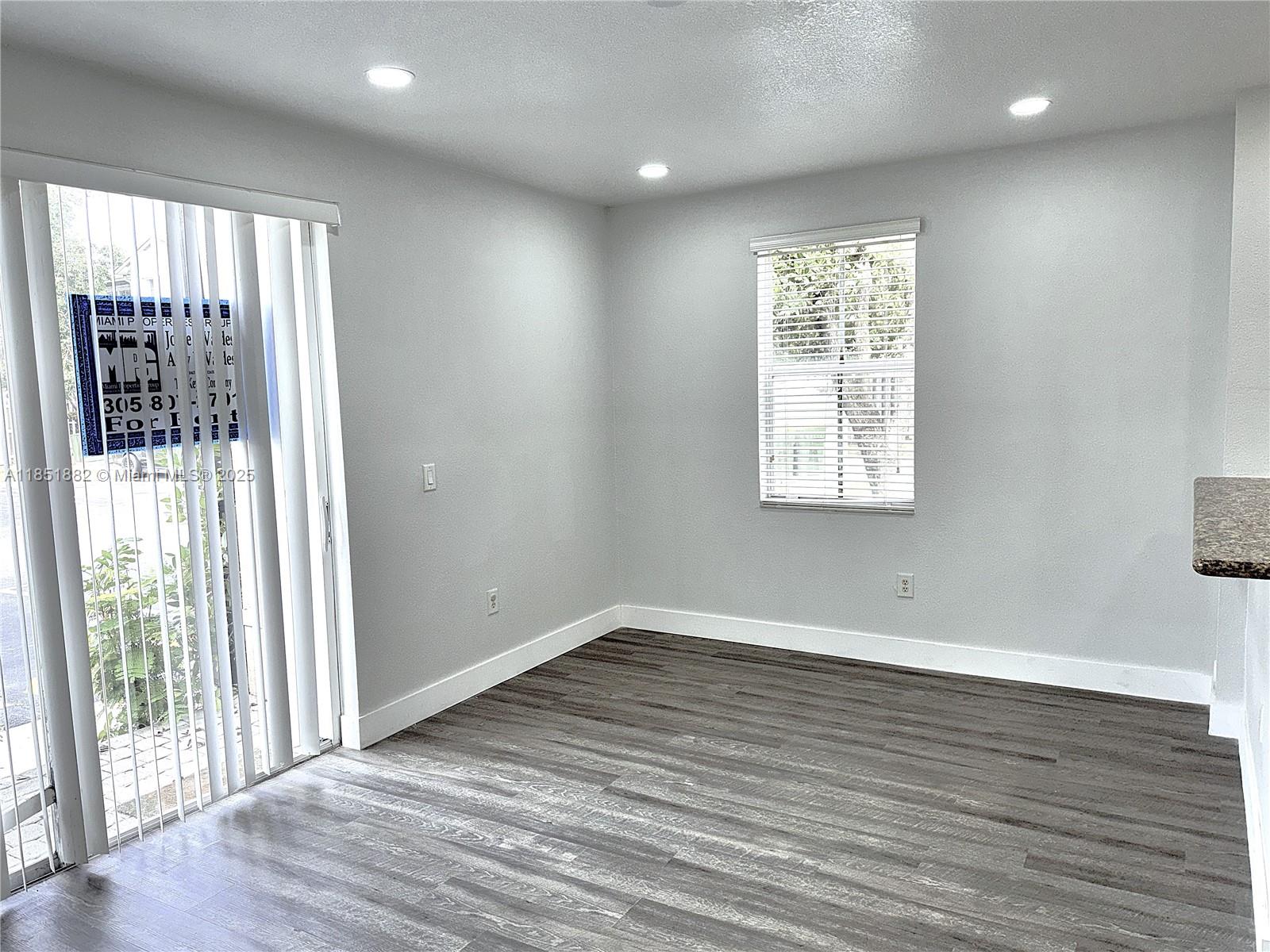 2933 Southeast 2nd Drive, Unit 2 Homestead, FL 33033 - Photo 19 of 38 an empty room with wooden floor and windows