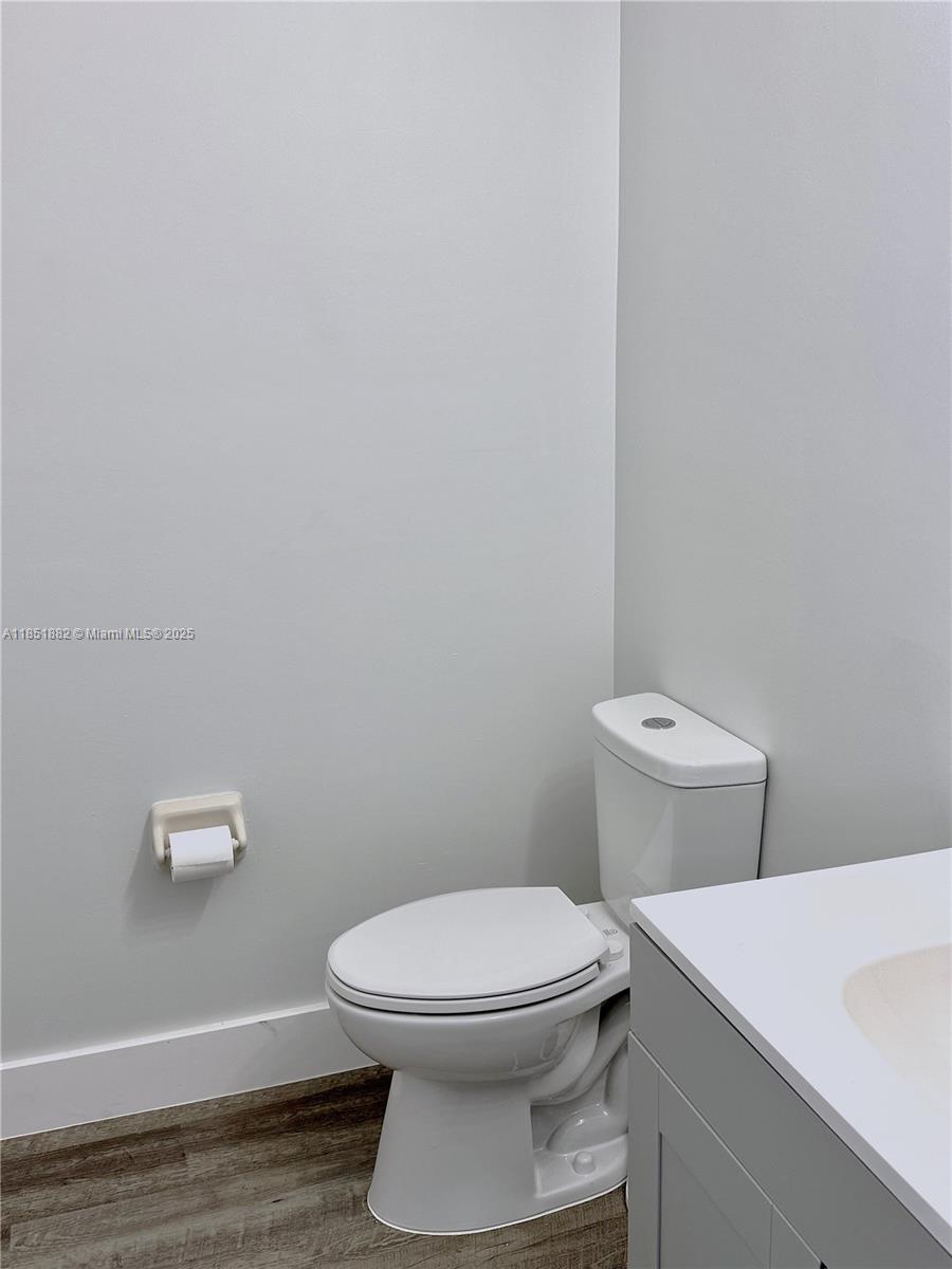 2933 Southeast 2nd Drive, Unit 2 Homestead, FL 33033 - Photo 23 of 38 a white toilet sitting next to a bathroom sink