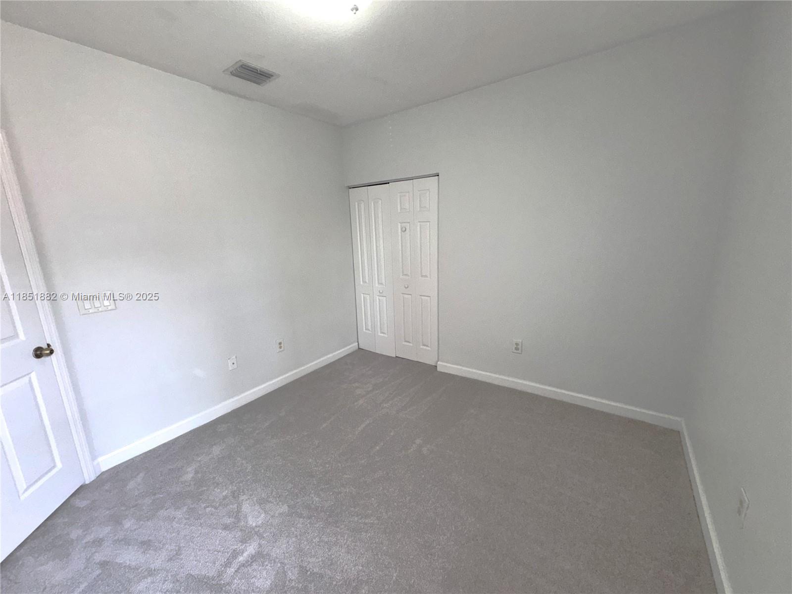 2933 Southeast 2nd Drive, Unit 2 Homestead, FL 33033 - Photo 27 of 38 an empty room with a empty space and windows