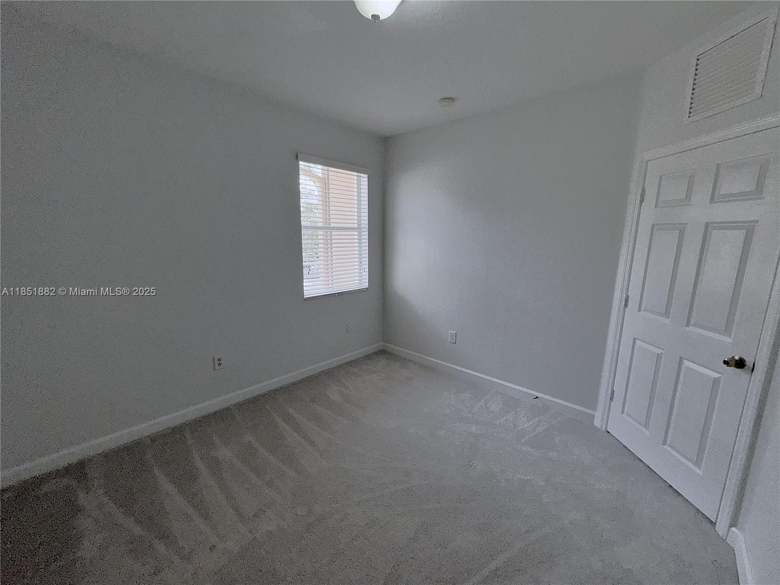 2933 Southeast 2nd Drive, Unit 2 Homestead, FL 33033 - Photo 28 of 38 an empty room with windows
