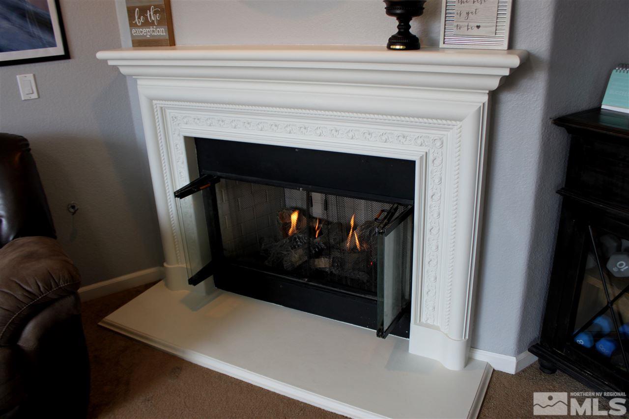 2495 Spring Flower Drive Reno, NV 89521 - Photo 12 of 30 a living room with a fireplace and a table