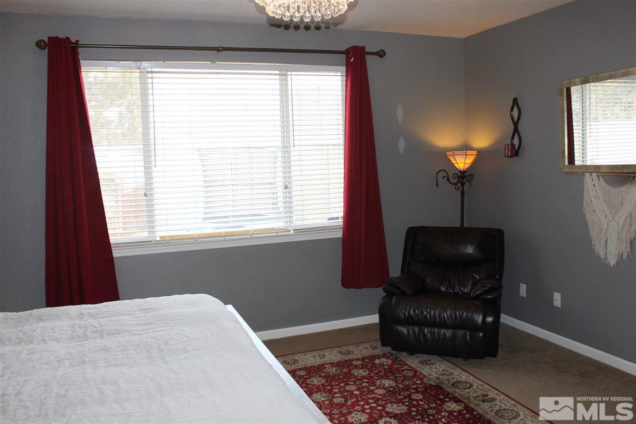 2495 Spring Flower Drive Reno, NV 89521 - Photo 16 of 30 a bedroom with a bed and a lamp