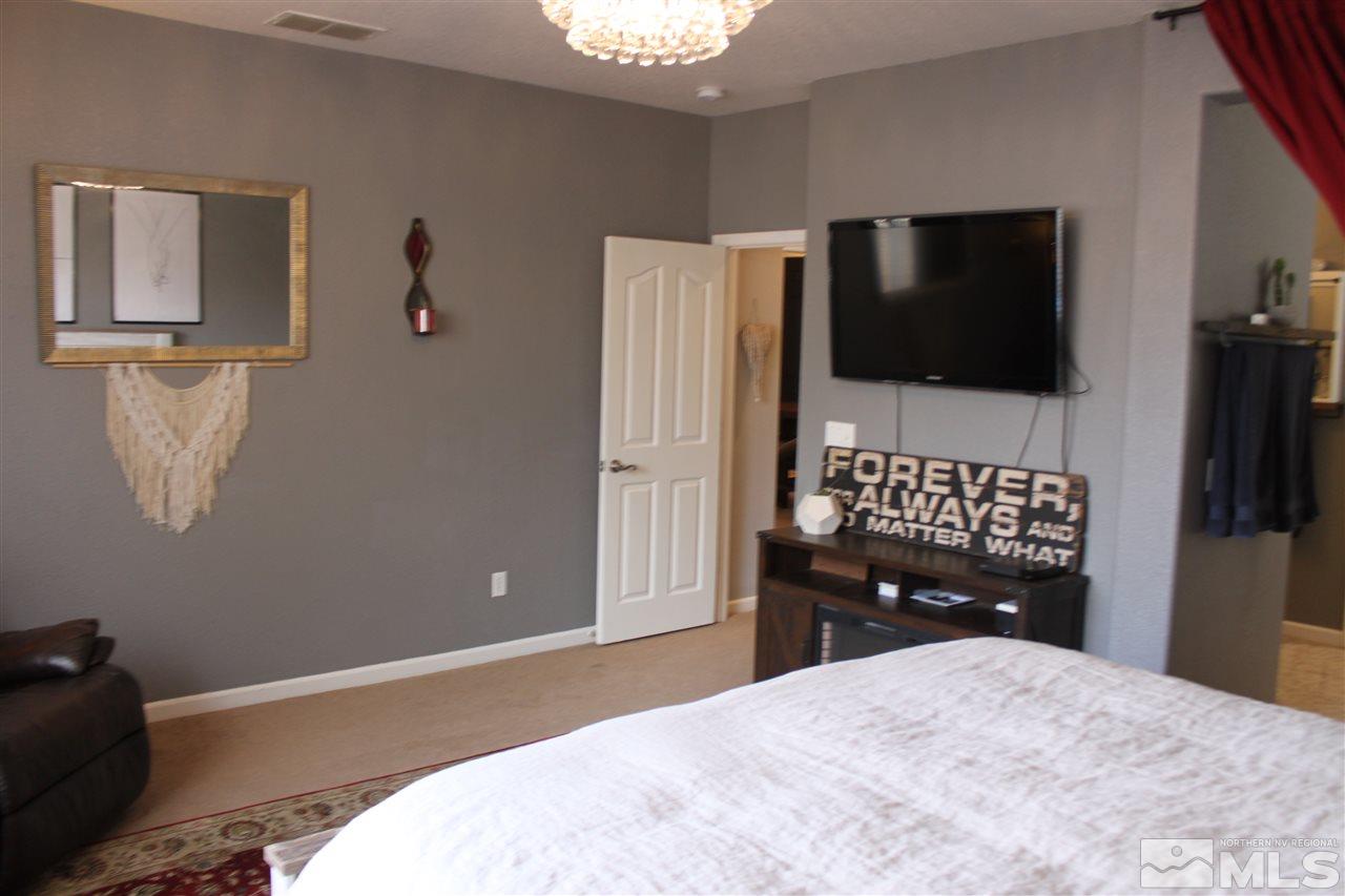 2495 Spring Flower Drive Reno, NV 89521 - Photo 17 of 30 a bedroom with a bed and a flat screen tv