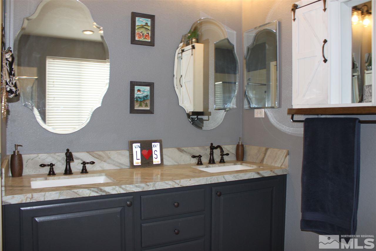 2495 Spring Flower Drive Reno, NV 89521 - Photo 19 of 30 a bathroom with double vanity sinks and a mirror