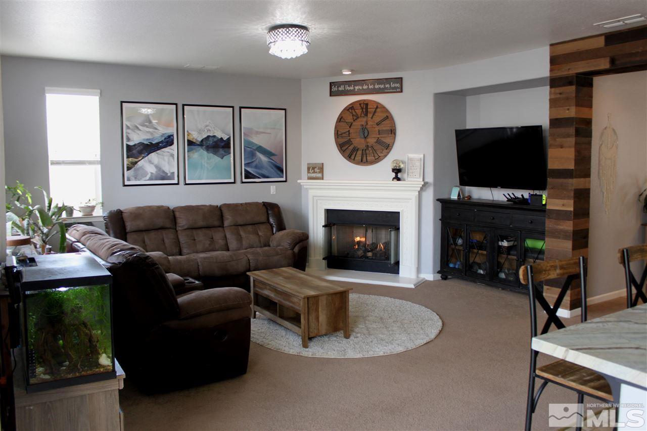 2495 Spring Flower Drive Reno, NV 89521 - Photo 2 of 30 a living room with furniture a flat screen tv and a fireplace