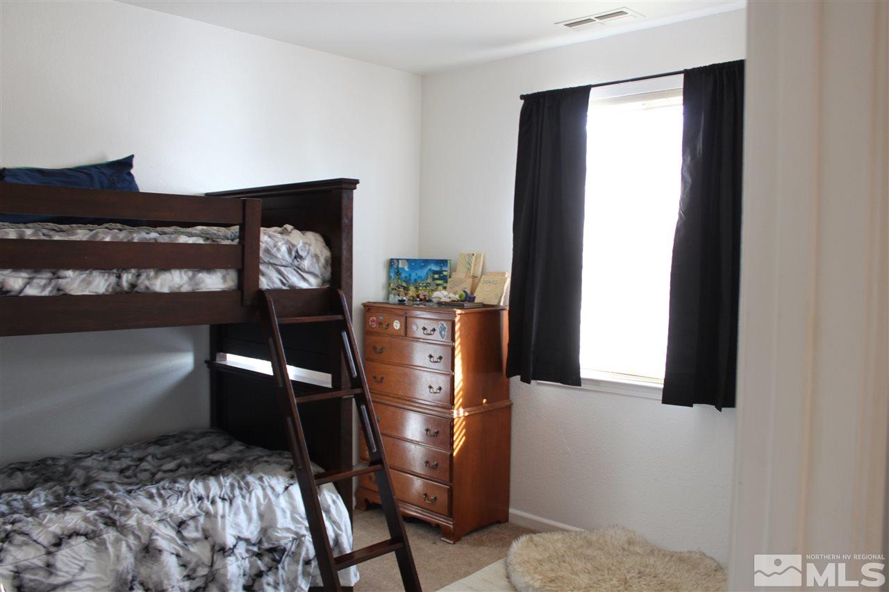 2495 Spring Flower Drive Reno, NV 89521 - Photo 21 of 30 a room with a bed and cabinets