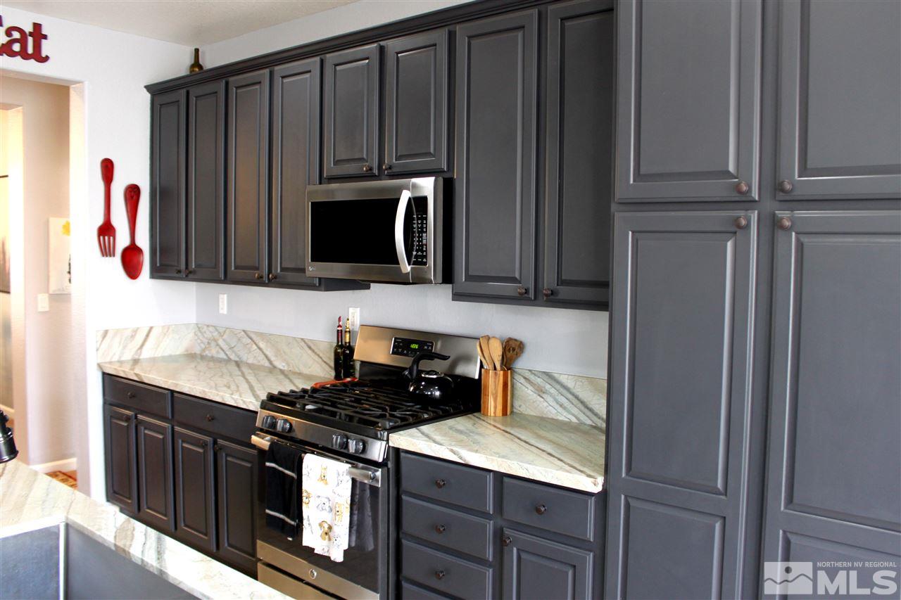 2495 Spring Flower Drive Reno, NV 89521 - Photo 6 of 30 a kitchen with stainless steel appliances granite countertop a refrigerator stove and microwave