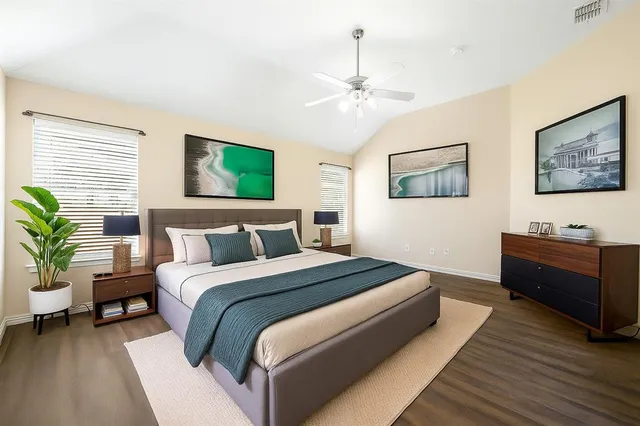 a spacious bedroom with a bed and a couch