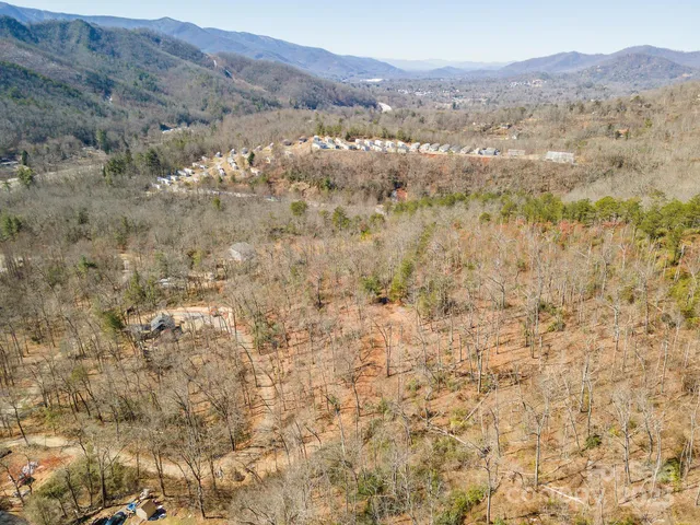 a view of a dry yard with mountains in the background