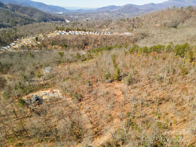 a view of a dry yard with mountains in the background