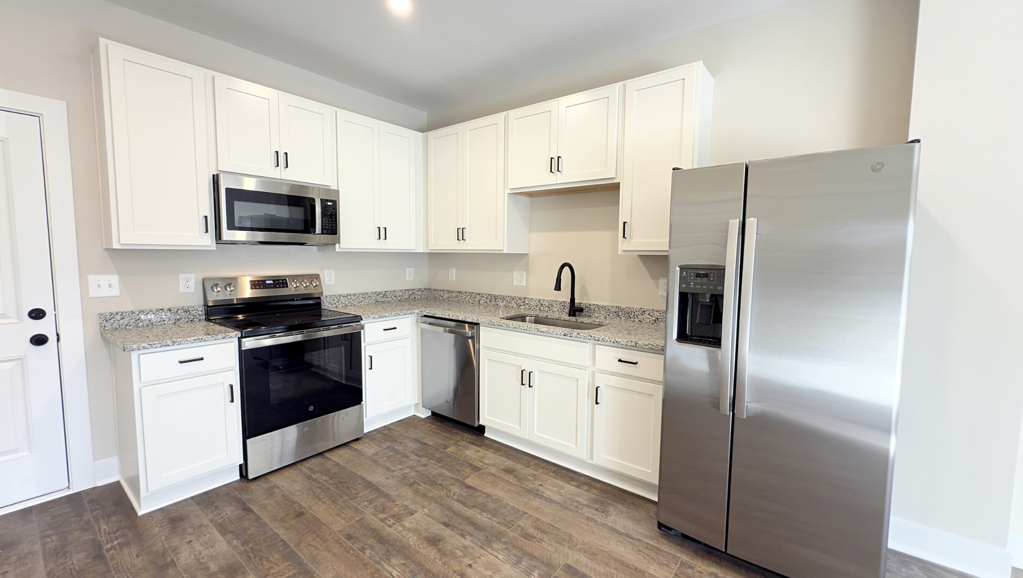 305 Pollard Road, Unit B Clarksville, TN 37042 - Photo 6 of 15 a kitchen with stainless steel appliances granite countertop a refrigerator stove a sink and a microwave