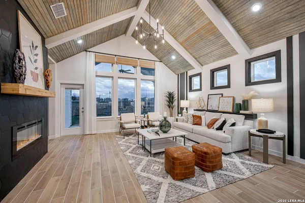 a living room with furniture a large window and a fireplace