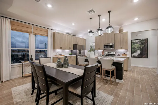 a large kitchen with a table and chairs