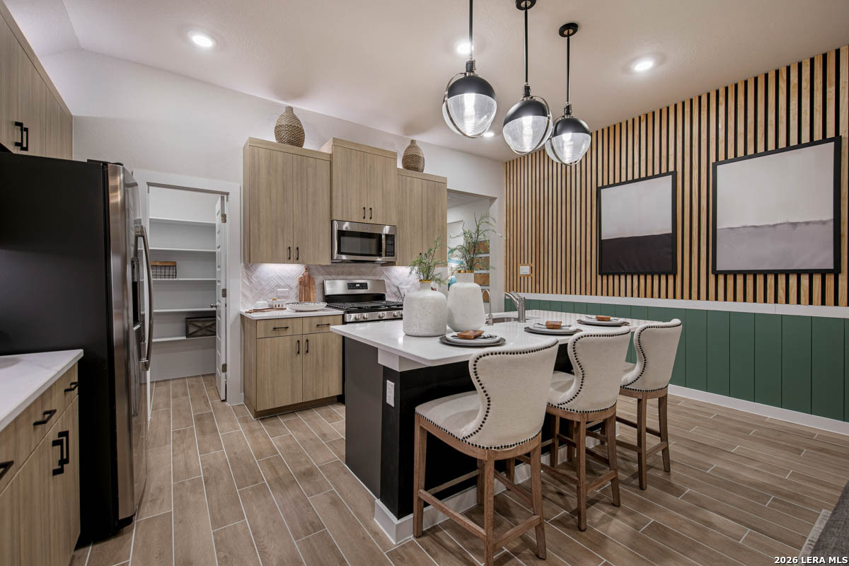 146 Stream Street Seguin, TX 78155 - Photo 15 of 27 a kitchen with sink cabinets stainless steel appliances and dining table