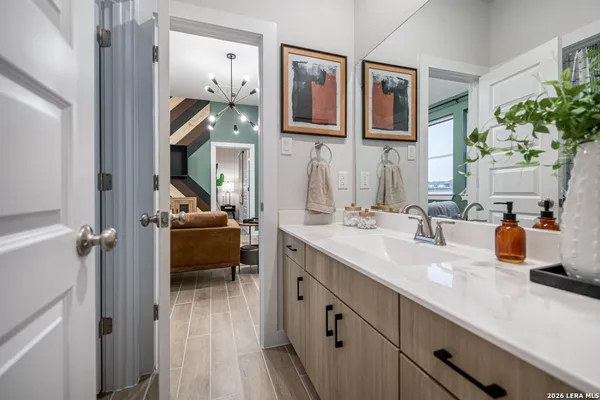 a en suite bathroom with a double vanity sink and a mirror