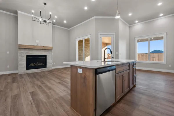 a kitchen with a sink chandelier and a stove top oven