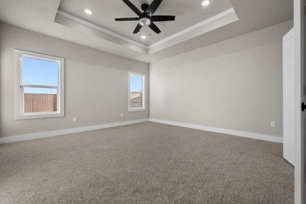 a view of an empty room and a ceiling fan