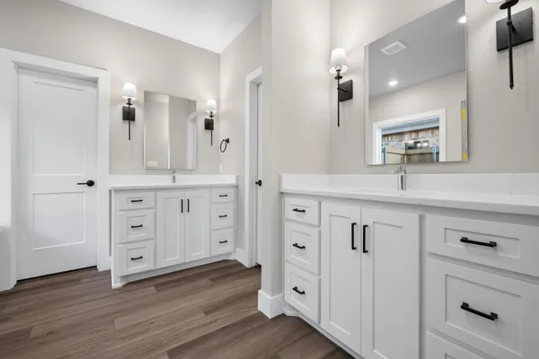a bathroom with a bathtub sink and mirror