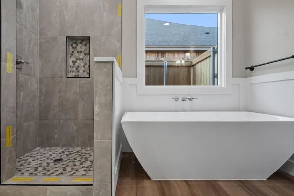 a view of cabinets wooden floors and entryway with white walls
